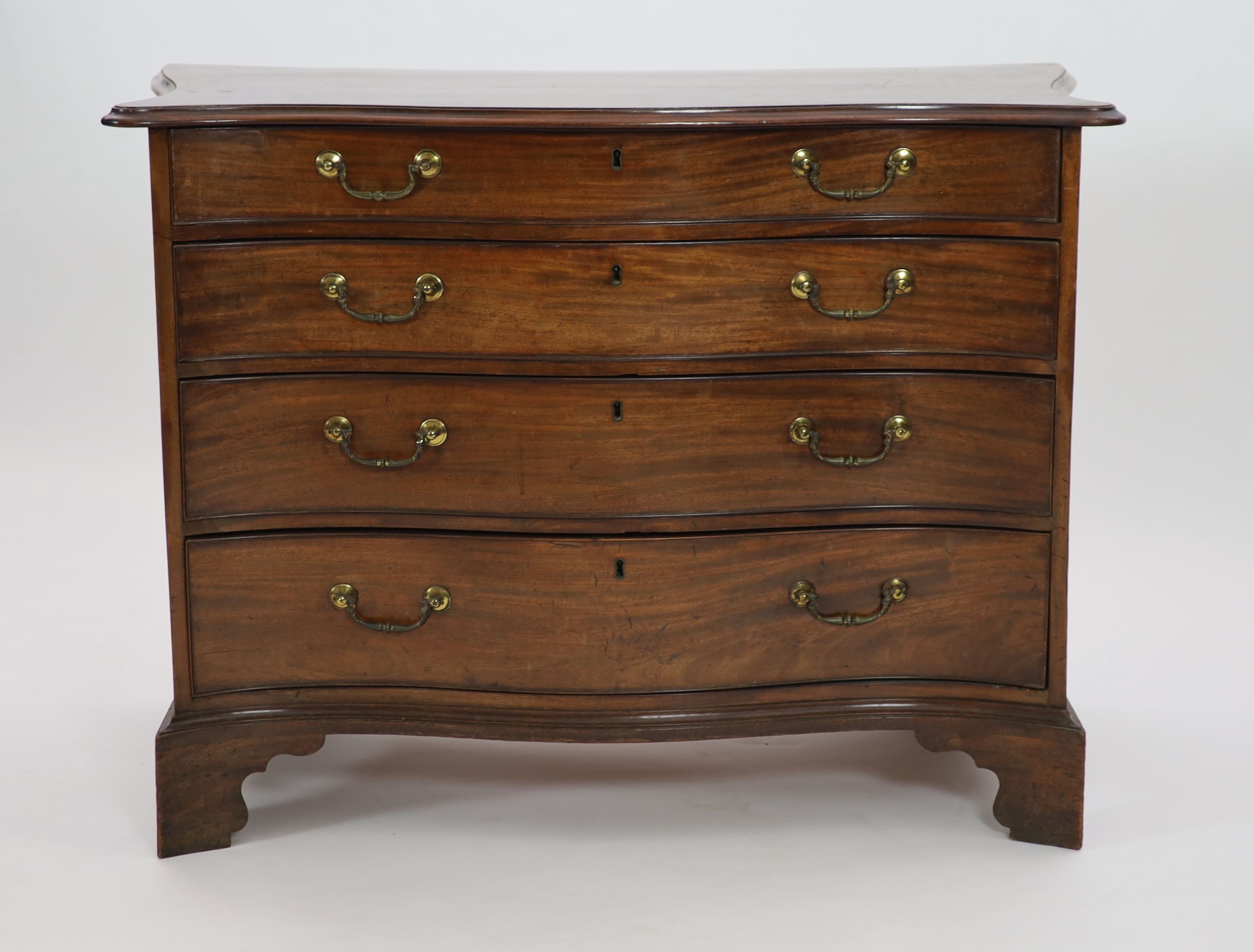 A George III serpentine mahogany chest, W.111cm D.55cm H.81cm
